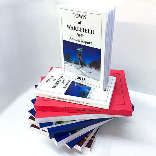 Town of Wakefield Annual Report Perfect Bound Book stacked on top of more books